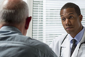 Doctor talking to older male patient