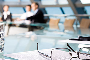 reading glasses laying on table over a peice of paper