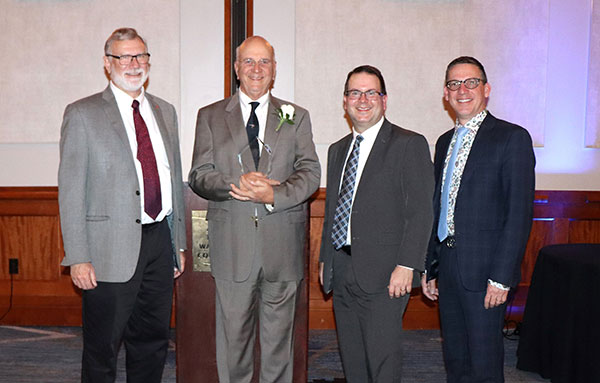 Wespath General Secretary Andy Hendren presents the Clay F. Lee Award to the Rev. Bill Wyman