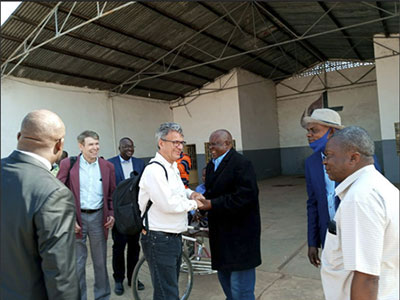 at the airport being greeted by retired Bishop Nkulu Ntanda Ntambo