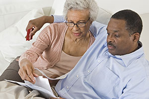 Older man and woman looking at bills