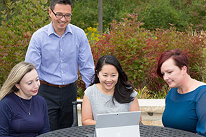 Wespath staff look at a computer