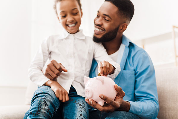 photo of people looking at a piggy bank