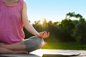 photo of a woman meditating outside