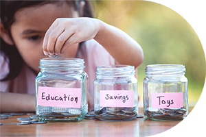 photo of child putting coins in jars