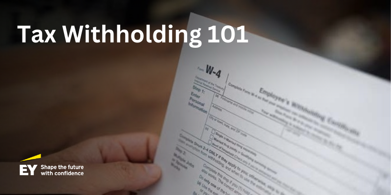 image of a hand holding a W-4 document
