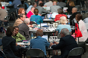photo of delegates at General Conference sitting at a table