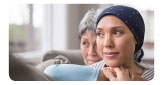 older woman standing behind younger woman