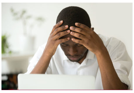 photo of a man stressed over financial information