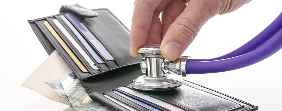 stethiscope being held to a wallet