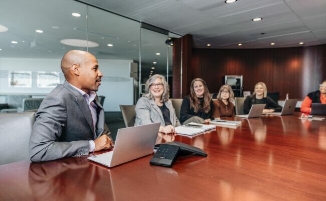 A group of business people sitting in a conference room