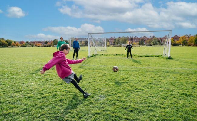 Kids playing soccer on field