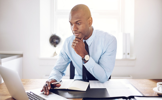 Man sitting at computer thinking