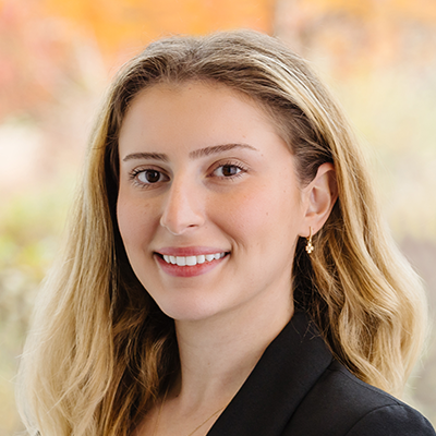 Bianka Hodo smiling with blonde hair and wearing a blazer.