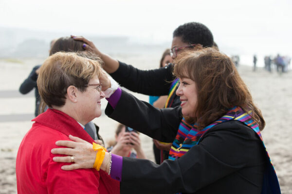 Bishop anointing people at state park