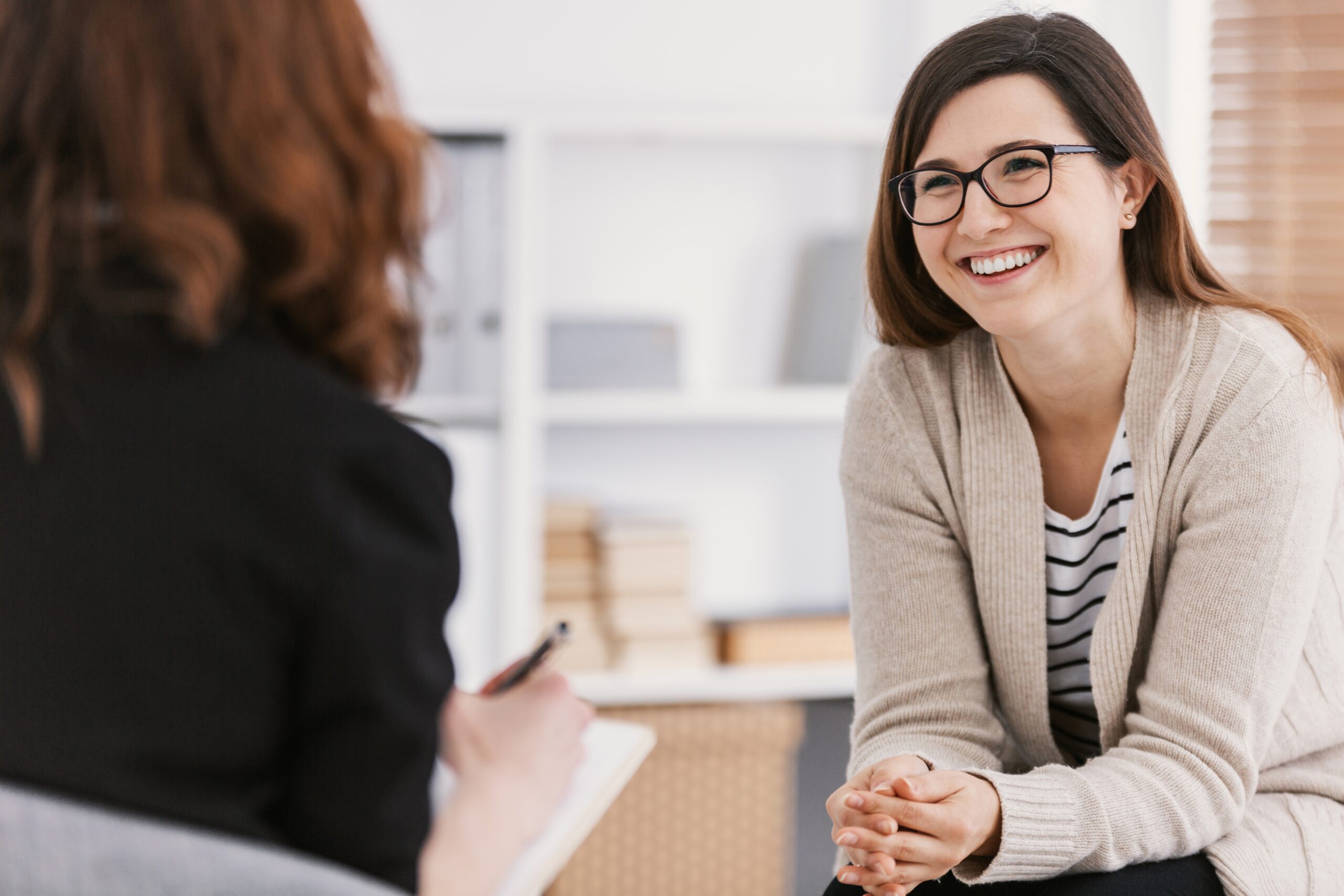 Two woman sitting and talking