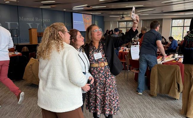 Attendees connecting and grabbing selfies with one another.