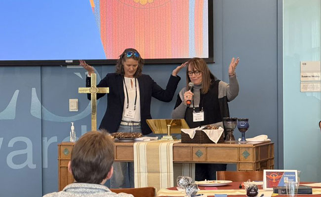Beata Ferris (Dakotas Annual Conference) and Bishop Lanette Plambeck leading closing worship and communion.